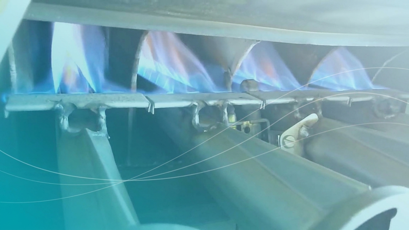 Close-up of heater burners being inspected during a repair